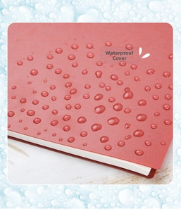 Macro detail of orange waterproof frosted PP cover for B5 binder notebook with water drops