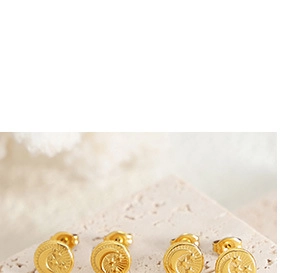 Macro shot of 14K gold plated celestial earrings featuring moon and star embossed details