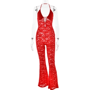 Detail of red lace halter jumpsuit with tie-front chest and flared leg on mannequin