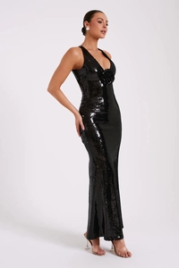 Detailed close-up of backless sequin dress with floral accent and mermaid tail