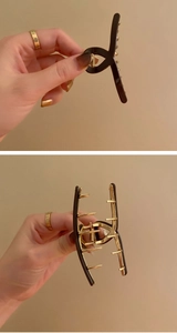 Close-up of a stylish black and gold metal hair claw clip shown from multiple angles