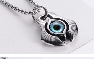 Detailed macro shot of a blue evil eye pendant with a polished silver bead chain