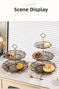 Detail of multi-tier glass fruit trays with wavy gold edges and luxury metal stand