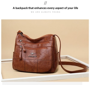 Detail of soft brown retro shoulder bag with multiple zippers and metallic kangaroo logo
