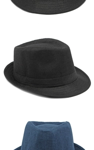 Detail of woven straw fedora hat featuring breathable texture and stylish ribbon band