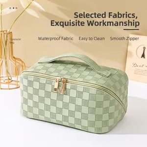 Waterproof checkered makeup bag in light green with double zippers and top handle