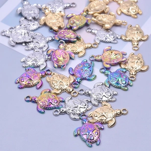 Detailed turtle charms in gold, silver, and rainbow finishes with starfish shell relief