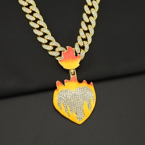 Close-up of hip hop gold Cuban chain with luminous flame heart pendant and rhinestones