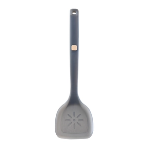 Dark gray heat-resistant silicone spatula with hollow flower pattern on white background