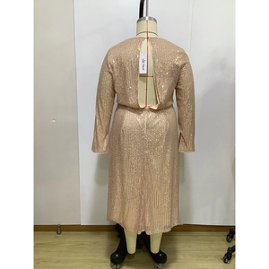 Detailed back view of champagne gold sequin dress with long sleeves and open back cutout