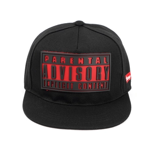 Detail of black hip hop cap with red Parental Advisory silicone patch and side tag