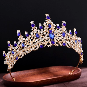 Elegant gold bridal crown featuring intricate metalwork and blue crystal gemstones