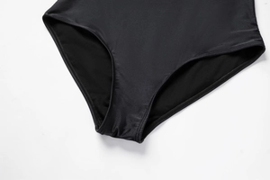 Detail of high-cut leg opening and premium stitching on black one-piece swimsuit