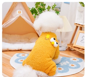 Detail of warm yellow lamb fleece pet jumpsuit with cartoon eyes and leash attachment