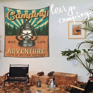 Détail d'une tapisserie de camping vintage avec illustration de lanterne et texte d'aventure