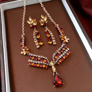 Vintage floral jewelry set with amber crystal necklace and matching drop earrings in gold