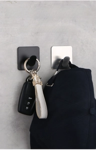 Detail of matte black and silver 304 stainless steel adhesive hooks holding items