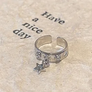 Detail of silver butterfly ring with star pendant and micro-set zircon accents