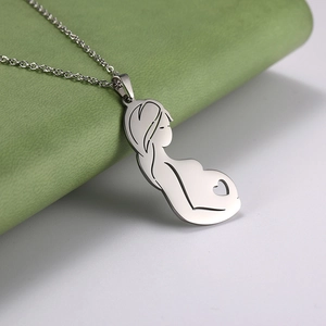 Silver stainless steel pendant showing a pregnant woman silhouette on a green leaf