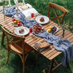 Overhead view of blue cheesecloth table runner for outdoor boho event table setting