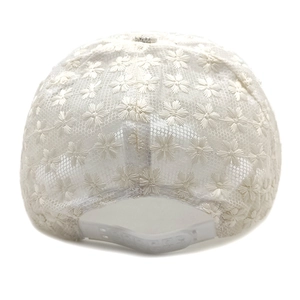 Detail of white lace daisy embroidery on baseball cap with adjustable strap buckle