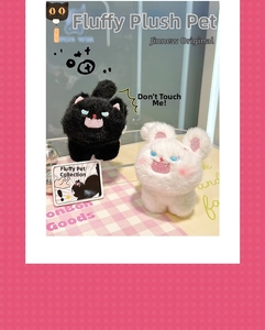 Detail of cute fluffy cat plush keychains in black and white with angry embroidered faces