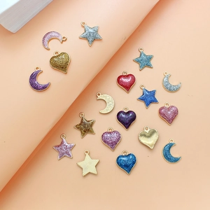 Macro shot of glitter enamel star moon heart charms for DIY jewelry making accessories