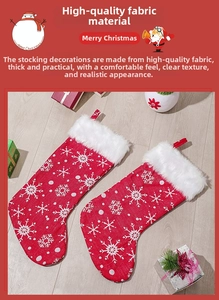 Close-up of red plush Christmas stockings with white snowflakes and faux fur trim decorations