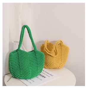 Detail of green and yellow handmade crochet knit bags with dense woven texture patterns