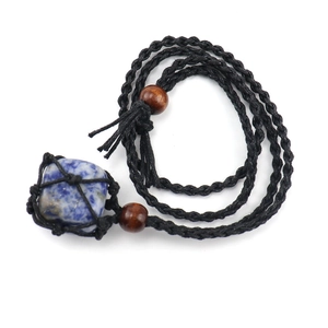 Detail of blue natural raw stone pendant secured in a black woven mesh net cord