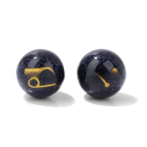 Macro detail of 10mm blue goldstone beads with Cancer zodiac sign for DIY jewelry