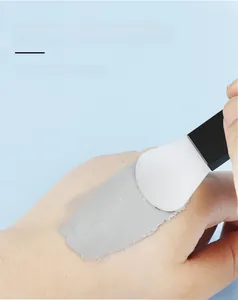 Silicone face mask brush applying mud mask evenly on skin for smooth skin care
