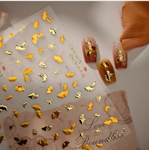 Detail of M-1247 ginkgo leaf nail stickers with gold foil and gradient orange autumn designs