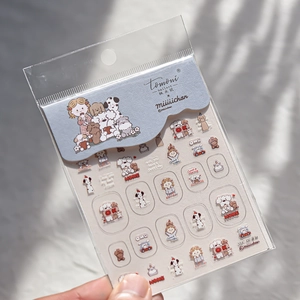 Close-up of cute cartoon dog nail art stickers featuring girl and puppy illustrations