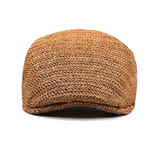 Detailed view of the tan woven texture on a vintage style summer sun hat