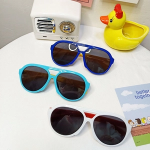 Close-up of stylish round frame kids sunglasses in blue and white with UV protection