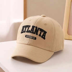 Detail of khaki kids baseball cap featuring 3D black Atlanta Georgia embroidery