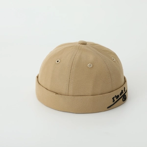 Detail view of khaki cotton docker hat showing I'm ok smile embroidery and stitching