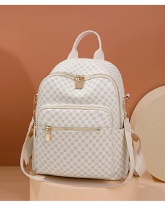 Detailed close-up of beige monogram backpack with luxury pattern and gold metal zipper