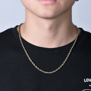 Polished gold and silver two-tone stainless steel rope chain necklace for men in close-up
