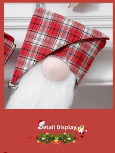 Detail of a Christmas gnome stocking featuring red plaid hat and a small metal bell