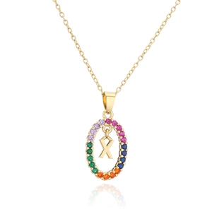 Detailed macro of gold letter X pendant with rainbow zircon stones on fine chain