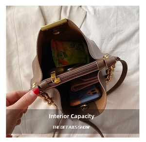 Internal view of brown leather bucket bag showing compartments and large capacity storage