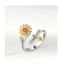 Detailed macro view of rotatable sunflower and bee ring with sparkling yellow zircons