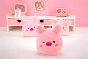 Close-up of cute pink plush pig coin purse with soft texture and a mini radio prop