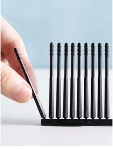 Detail of hand taking a black disposable adhesive ear swab from the plastic storage base