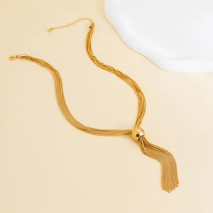 Macro view of layered gold snake chains and central metallic sphere with tassels