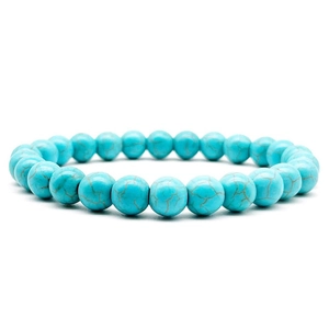 Close-up of 8mm natural turquoise beads bracelet with brown matrix on white background