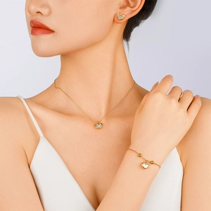 Elegant gold heart jewelry set featuring shell inlay necklace and earring pieces