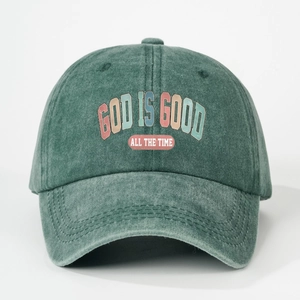 Vintage green washed cotton baseball cap with God Is Good slogan and adjustable strap